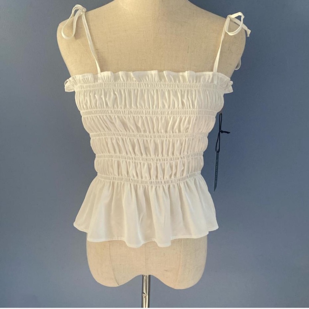 White cinched tank top with adjustable tie details on shoulders
